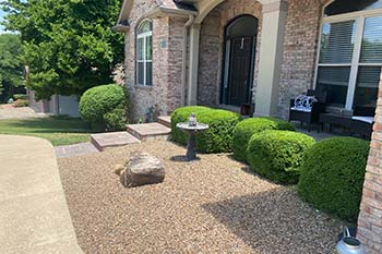 Trimming and pruning in a landscaping bed completed by McVey Mowing in Columbia.