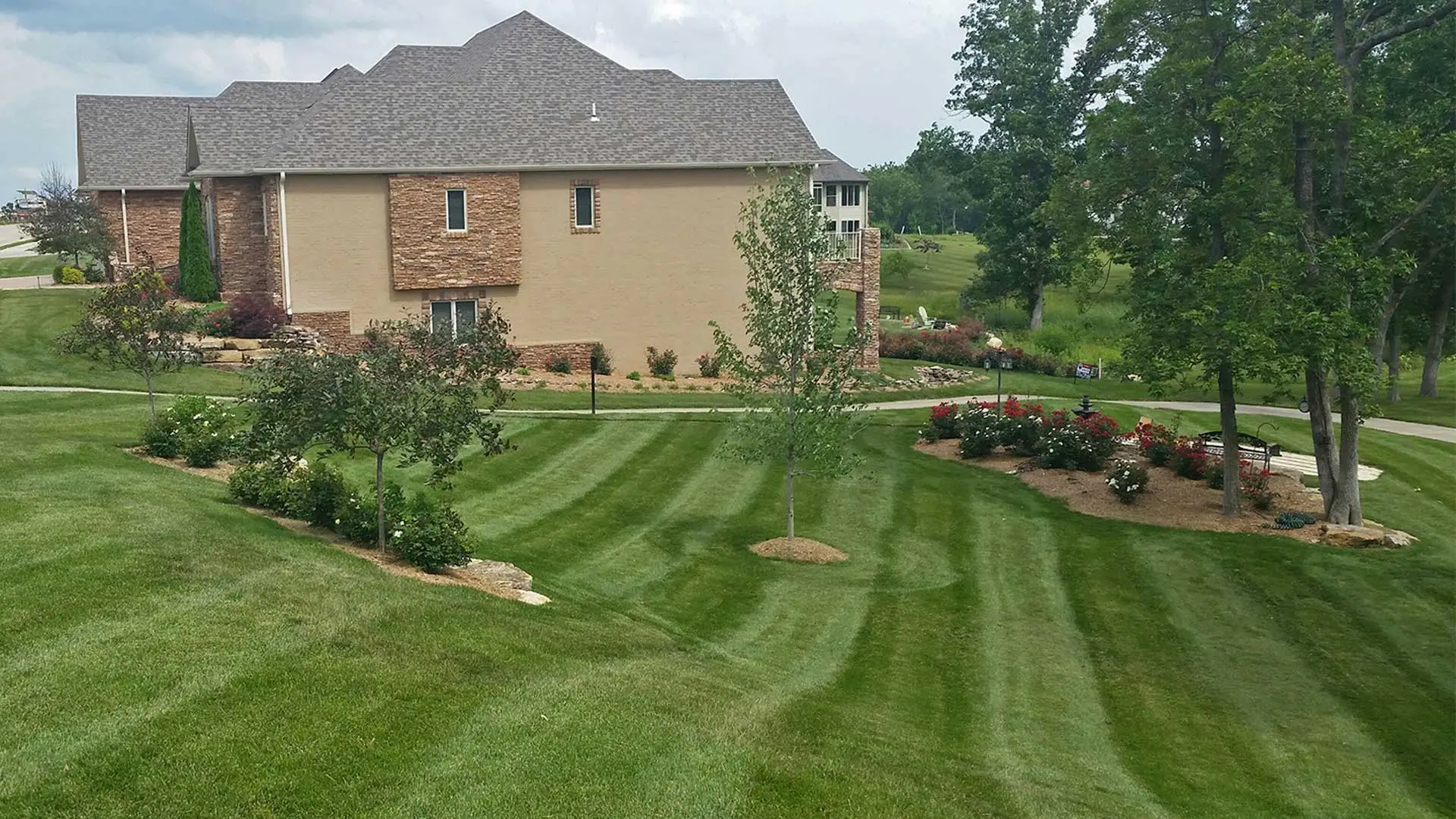 Well maintained lawn and landscaping at residential property.